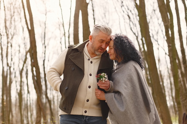 Free photo elegant adult couple in a spring forest