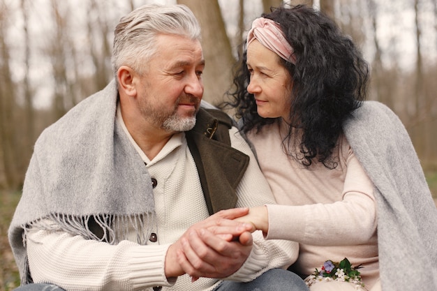 Elegant adult couple in a spring forest