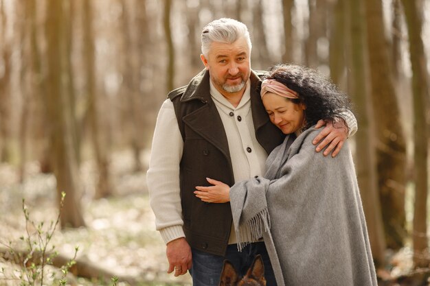 Free photo elegant adult couple in a spring forest