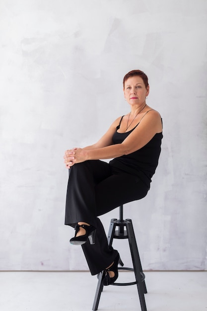 Elegant beautiful woman sitting on a stool