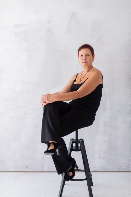 Elegant beautiful woman sitting on a stool