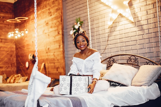 Elegant black girl in the Christmas decorations