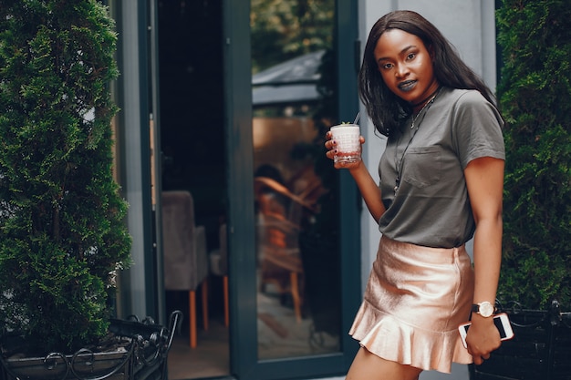 Elegant black girl in a summer city