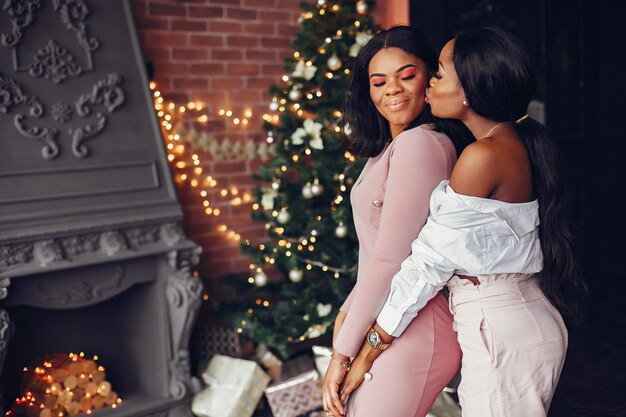 Elegant black girls in the Christmas decorations