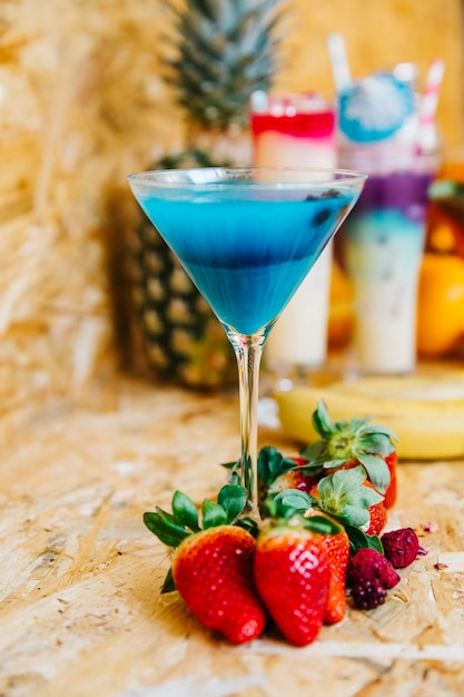 Elegant blue cocktail and strawberries
