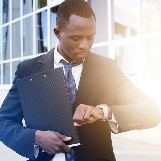 Elegant businessman checking time