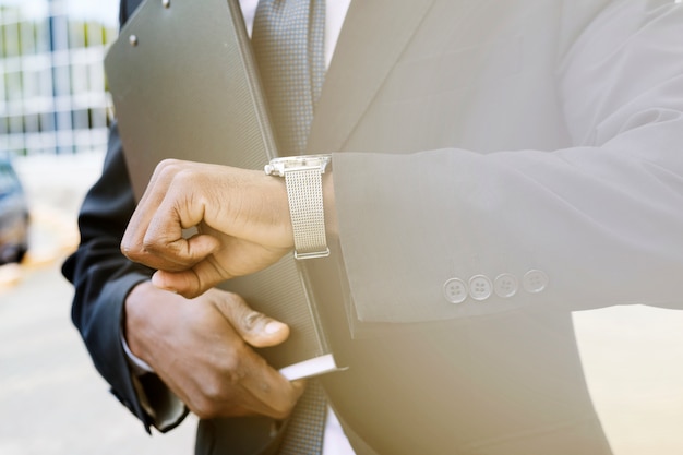 Elegant businessman checking time