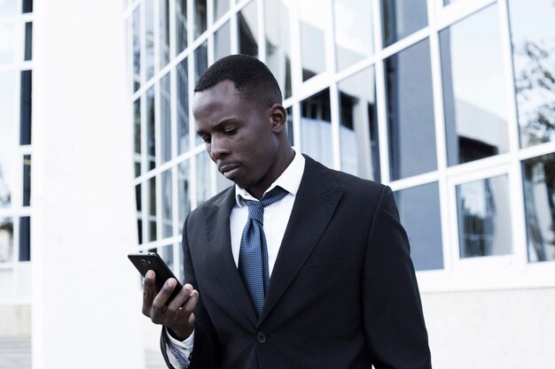 Elegant businessman looking at smartphone