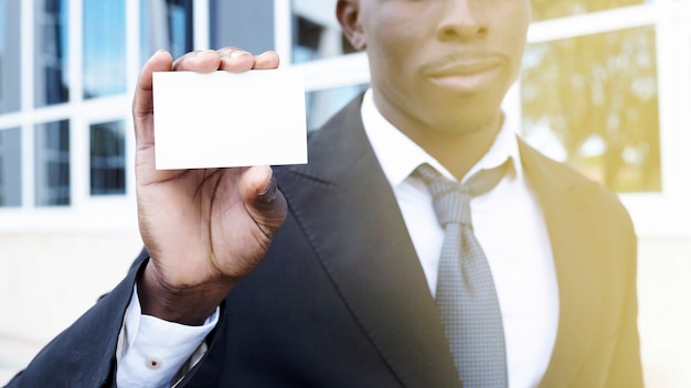 Free photo elegant businessman presenting business card