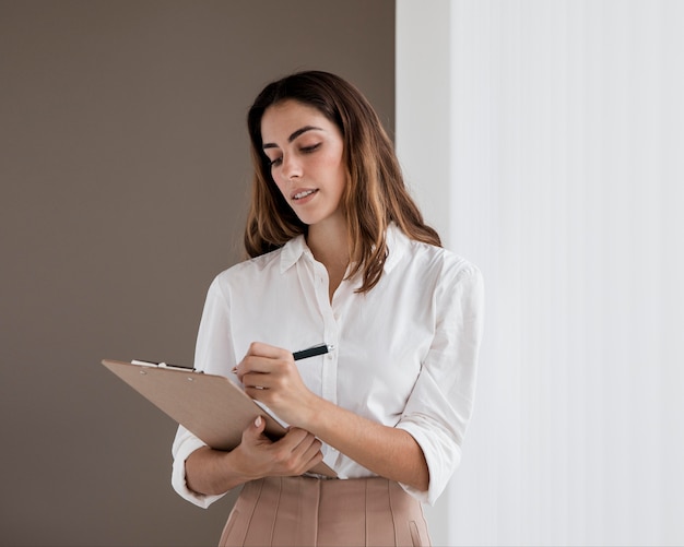 Elegant businesswoman holding clipboard