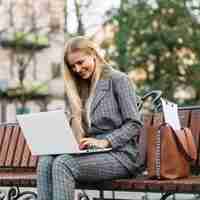 Free photo elegant businesswoman sitting on bench