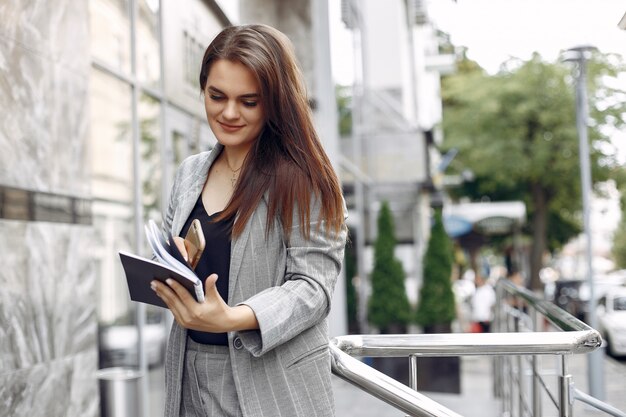 Elegant businesswoman working in a city and use the notebook