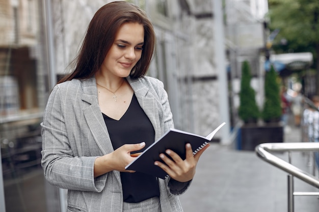 Elegant businesswoman working in a city and use the notebook