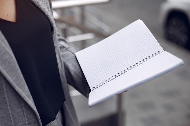 Elegant businesswoman working in a city and use the notebook