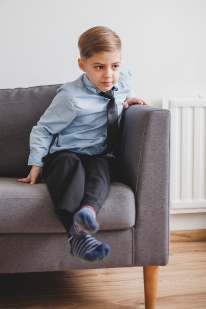 Elegant child sitting on an couch