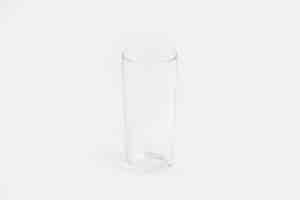 Free photo elegant clear glass cup isolated on a white wall