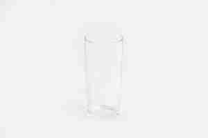 Free photo elegant clear glass cup isolated on a white wall