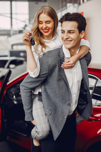 Elegant couple in a car salon