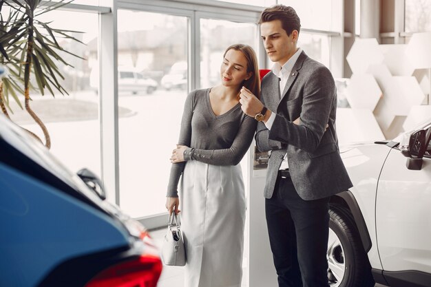 Elegant couple in a car salon