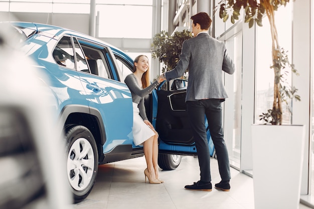 Elegant couple in a car salon