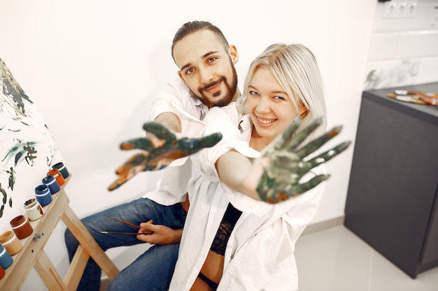 Free photo elegant couple draws in an art studio