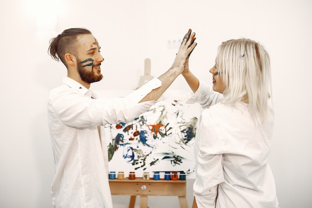 Elegant couple draws in an art studio