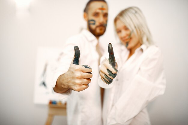 Elegant couple draws in an art studio