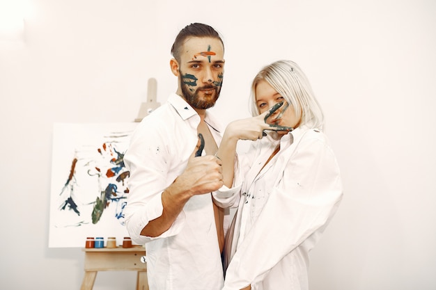 Free photo elegant couple draws in an art studio