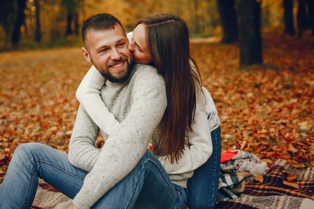 Elegant couple spend time in a autumn park