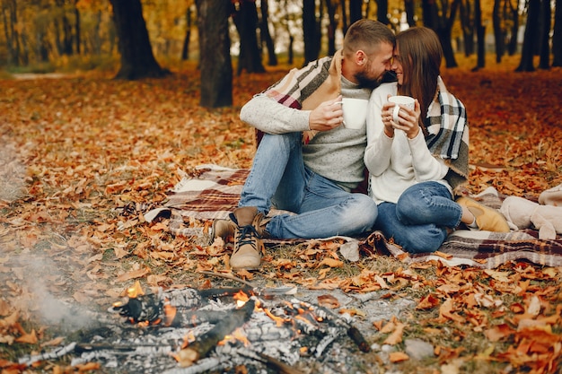 Elegant couple spend time in a autumn park