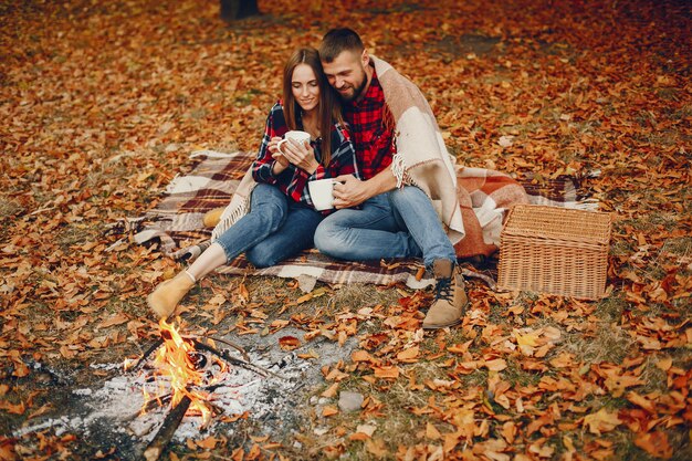 Elegant couple spend time in a autumn park