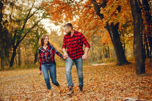 Elegant couple spend time in a autumn park