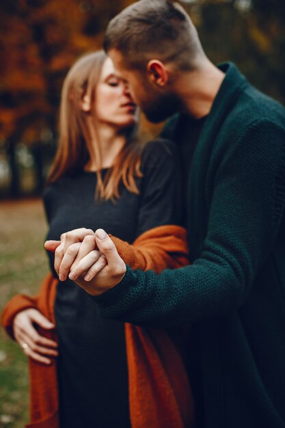 Elegant couple spend time in a autumn park