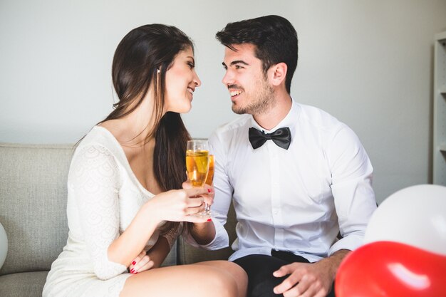 Elegant couple toasting and smiling to each other's face