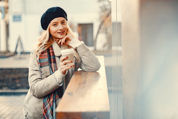 Elegant cute blonde in a autumn city