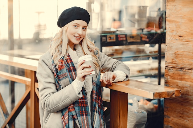 Elegant cute blonde in a autumn city