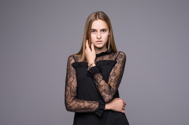 Elegant fashionable woman in black dress standing