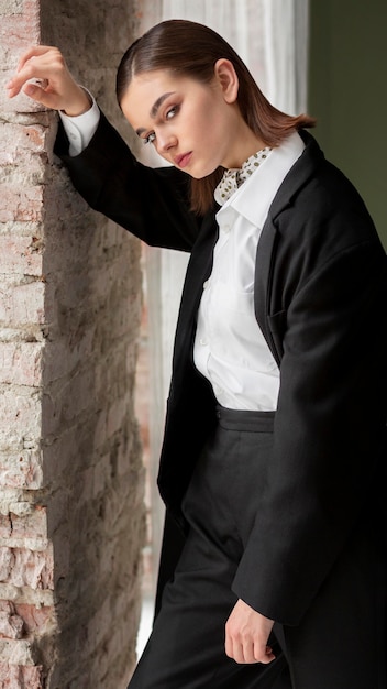 Elegant female model posing in a jacket suit with a tie. new feminity concept