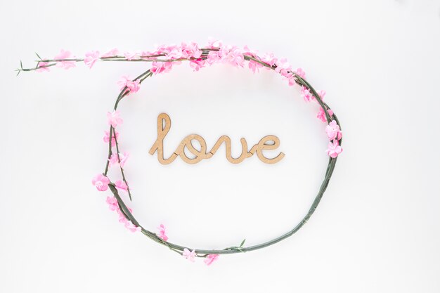 Elegant flower wreath around love inscription