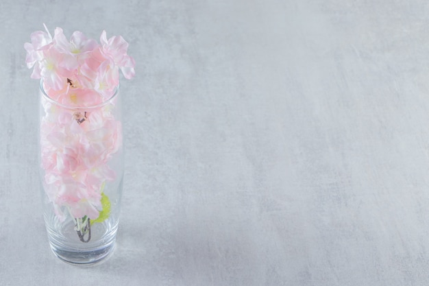 Elegant flowers in a jug, on the white table