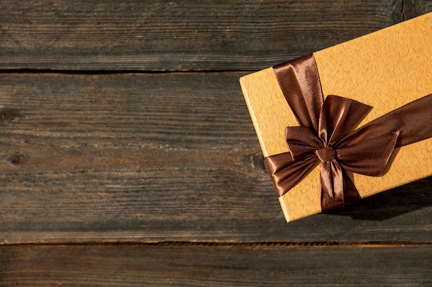 Elegant gift on wooden background