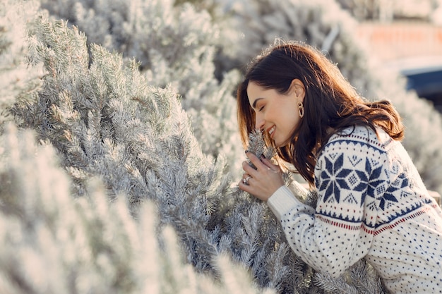 Elegant girl buys a Christmas tree.