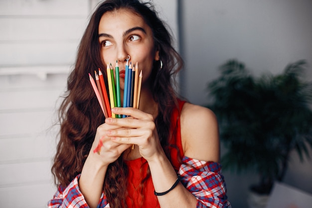 Elegant girl draws in an art studio