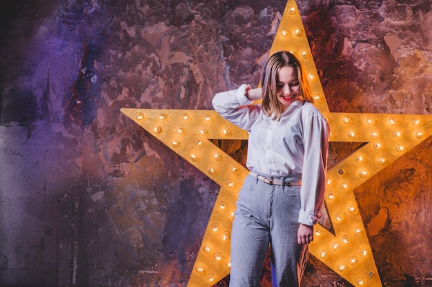 Elegant girl holding hair at star