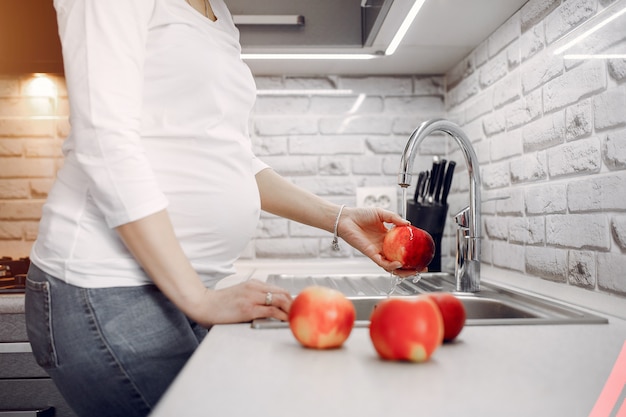 Foto gratuita ragazza elegante in una cucina con frutta