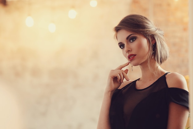 Elegant and glamorous woman with makeup posing, fashion concept