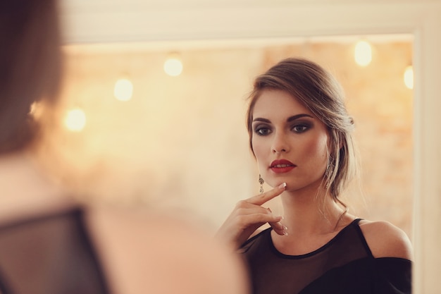 Elegant and glamorous woman with makeup posing, fashion concept