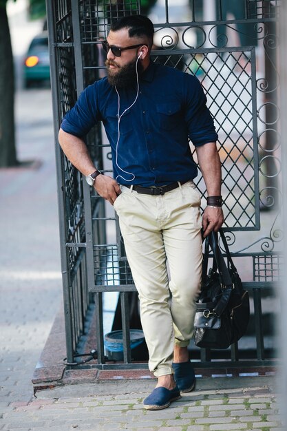 Free photo elegant guy posing while listening to music