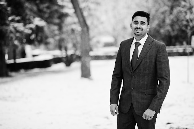 Elegant indian fashionable man model on suit posed at winter day