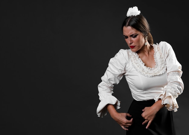 Elegant lady in flamenco dress performing